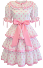 Polka dot dress with pink accents on a white background