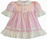 Pink and white dress with ruffled details on a white background