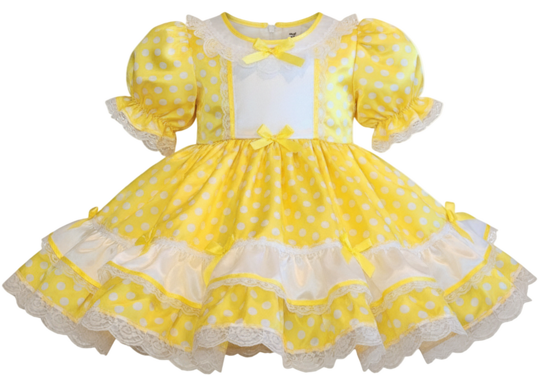Yellow polka dot dress with white accents on a white background