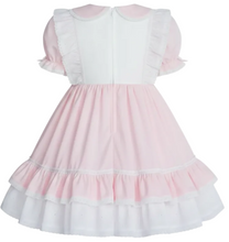 A pink and white adult sissy dress with short ruffled sleeves and a Peter Pan collar, shown from the back on a white background.