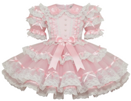 Pink sheer dress with lace and bows on a white background