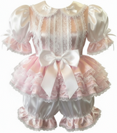 Lace adult baby romper with pink ruffles and a white bow on a white background