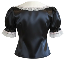 Black satin short-sleeve blouse with lace trim on the collar and cuffs, displayed on a mannequin torso against a white background.