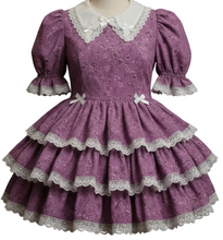 Purple lace dress on a mannequin in a store setting