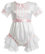 White satin adult baby romper with pink ribbon trim, short puff sleeves, lace ruffles, and a bow detail on the chest.