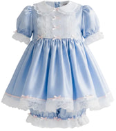 A light blue and white adult little girl's dress with short puff sleeves, a white lace Peter Pan collar, lace trim on the bodice, and a layered ruffled hem with small pink bows.
