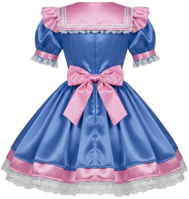 A blue and pink satin dress with short puff sleeves, a large pink bow at the waist, and white lace trim, shown on a plain light gray background.