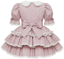 A floral print sissy dress with puff sleeves, a large bow at the waist, and a tiered ruffled skirt with white lace trim, shown against a plain white background.