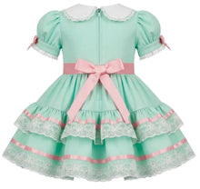 A mint green and pink adult baby girl's dress with a white lace Peter Pan collar, short puff sleeves, a large pink ribbon bow at the waist, and layered ruffles with white lace trim.