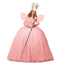 Person in a pink Glinda fairy costume with a crown and wand on a white background