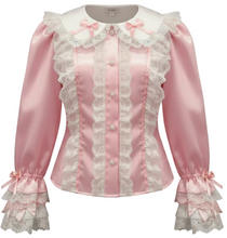 A pink satin long-sleeve blouse with white lace trim, ruffles, a white collar, shown on a plain white background.