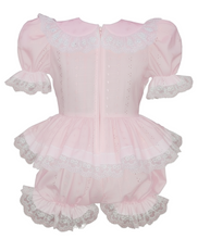 Pink romper with lace details on a white background