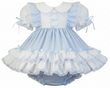 Pink and white adult baby dress with ruffles on a white background