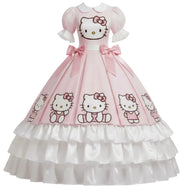 A pink and white Hello Kitty gown with puff sleeves, a white Peter Pan collar, and a full tiered ruffled skirt featuring multiple Hello Kitty character prints.