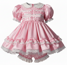 Pink dress with white lace details on a white background