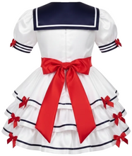 A white sissy dress with a navy blue sailor collar and a large red bow at the waist, shown from the back on a white background.