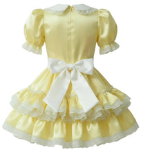 A pale yellow adult baby girl's dress with a white collar, puffed short sleeves, a large white bow at the waist, and a tiered ruffled skirt with white lace trim, shown from the back on a white background.