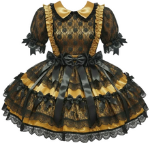 Black and gold dress with lace details on a white background