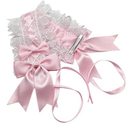 A pink satin and white lace headband set with large bows, delicate lace trim, and long ribbon tails, shown on a plain white background.