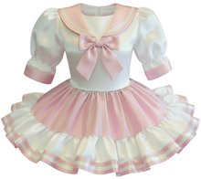 Pastel-colored dress with a large pink bow on a white background