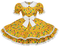 Yellow dress with colorful polka dot pattern and white collar on a white background