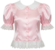 A pink satin blouse with a white satin Peter Pan collar, ruffled cuffs, and a ruffled hem, featuring decorative buttons down the front.