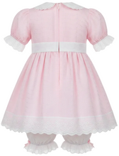 An adult baby girl's pink dress with white lace trim, a white Peter Pan collar, and white ruffled bloomers, displayed on a dress form against a white background.