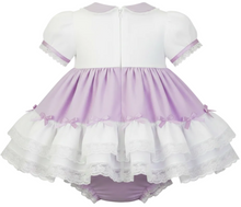 A sissy baby girl's short-sleeve dress with a white bodice, lavender skirt, and white lace trim, shown from the back on a white background.