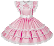A pink satin sissy dress with white lace trim, ruffled cap sleeves, a Peter Pan collar, and a tiered skirt, shown on a plain white background.