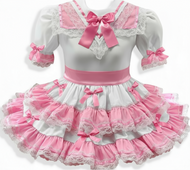 Pink and white dress with lace details on a white background