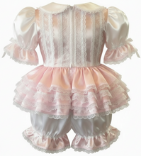 Pink and white lace adult baby outfit on a white background