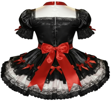 Black satin dress with black lace and red bows on a hite background