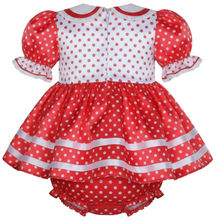 Red polka dot baby dress with a bow on a white background