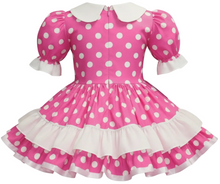 Pink polka dot dress with white collar and ruffled skirt on a white background