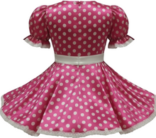 Pink dress with white polka dots on a white background