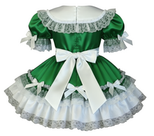 Green dress with white lace and ribbons on a white background
