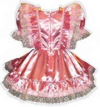 Pink satin dress with lace trim on a white background