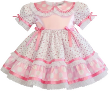 Pink and white dress with floral patterns on a white background