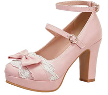 A light pink platform high-heeled shoe with a Mary Jane strap, ankle strap, lace detail, and a large bow on the toe, shown against a plain white background.