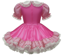 Pink dress with checkered sleeves and lace details on a white background