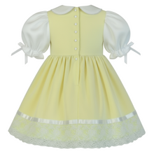 Yellow dress with white collar and sleeves on a white background