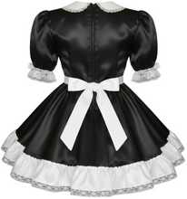 Black satin dress with white lace trim and a bow on a white background