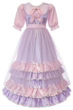 A pink and purple tiered Lolita-style dress with short puff sleeves, a lace-trimmed neckline, and multiple ruffled layers with bows, shown on a plain white background.