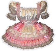 A pink and white satin sissy dress with lace trim and satin ribbon bows, featuring a Swiss maid style with elasticized sleeve ends and a full gathered skirt.
