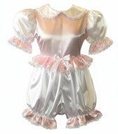 A pink and white satin romper with lace trim and a satin ribbon bow, designed for adult wear.